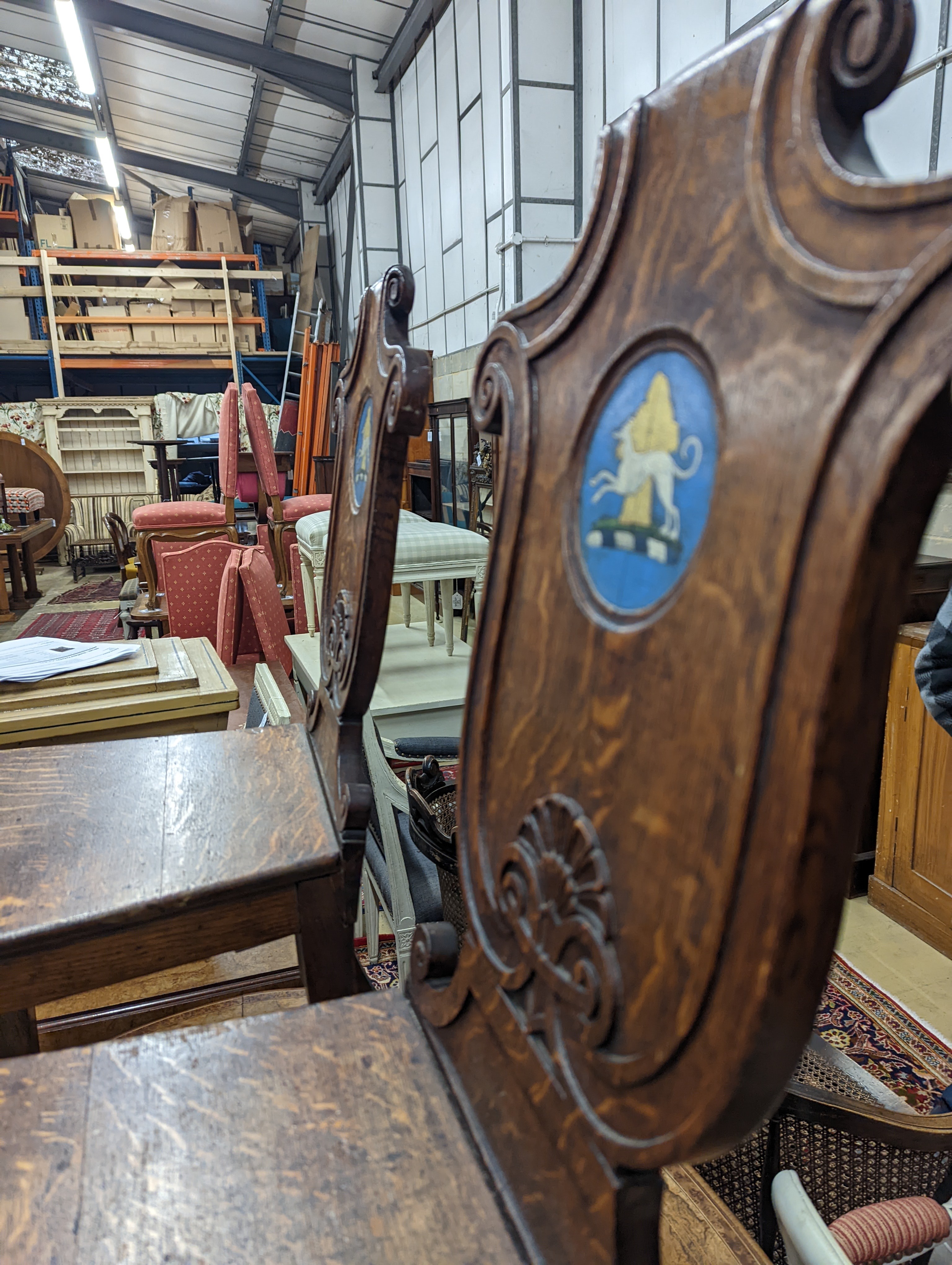 A pair of Victorian oak hall chairs with painted armorials, width 43cm, depth 39cm, height 94cm